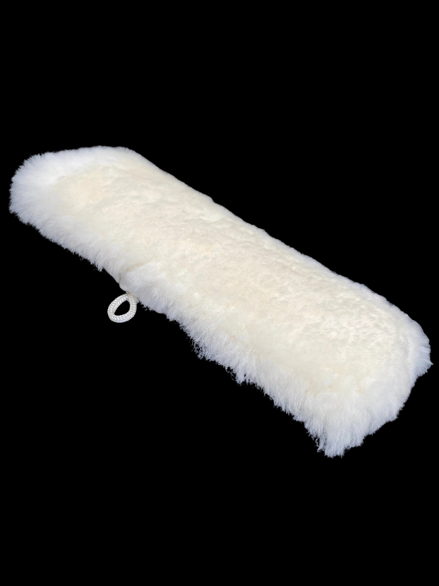 A white fluffy faux fur sleeve or cover with a small white plastic ring, shown on a dark textured background.